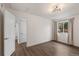 Bedroom featuring hardwood floors, generous natural light, and ensuite bath at 835 S Shoshone St, Denver, CO 80223
