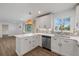 Updated kitchen with a stylish wicker light fixture, stainless steel appliances, and bright countertops at 835 S Shoshone St, Denver, CO 80223