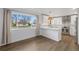 Modern kitchen with white cabinets, stylish backsplash, and plenty of natural light at 835 S Shoshone St, Denver, CO 80223