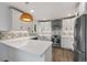Modern kitchen with white cabinetry, stainless steel appliances, and a unique backsplash at 835 S Shoshone St, Denver, CO 80223