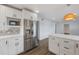 Bright kitchen with stainless steel appliances and center island that opens to a spacious living area at 835 S Shoshone St, Denver, CO 80223