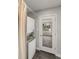 Functional laundry room featuring a stacked washer and dryer, with a glass door exit at 835 S Shoshone St, Denver, CO 80223