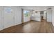 Bright, open living room with wood floors and a view to the kitchen at 835 S Shoshone St, Denver, CO 80223