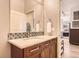 Lovely bathroom featuring a modern vanity, granite countertop, and stylish decorative tile backsplash at 5401 S Park Terrace Ave # 109A, Greenwood Village, CO 80111