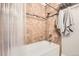 Clean bathroom featuring a shower-tub combo with tiled walls and modern fixtures at 5401 S Park Terrace Ave # 109A, Greenwood Village, CO 80111