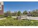 Eye-level sign reading '5401 Village Plaza Lofts' with mature landscaping and residential buildings in the background on a sunny day at 5401 S Park Terrace Ave # 109A, Greenwood Village, CO 80111