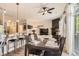 Elegant dining area with a large table, stylish chairs, and a view into the living room at 5401 S Park Terrace Ave # 109A, Greenwood Village, CO 80111