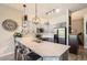 Modern kitchen featuring granite countertops, stainless steel appliances, a breakfast bar, and stylish pendant lighting at 5401 S Park Terrace Ave # 109A, Greenwood Village, CO 80111