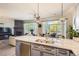 Spacious open floorplan kitchen featuring gray cabinets, a large center island, and a view of the living and dining areas at 5401 S Park Terrace Ave # 109A, Greenwood Village, CO 80111
