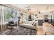 Bright open concept living room and kitchen with a ceiling fan, modern lighting, and a view to the dining room and patio at 5401 S Park Terrace Ave # 109A, Greenwood Village, CO 80111