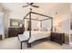 Comfortable main bedroom with a four-poster bed, dresser, and modern decor at 5401 S Park Terrace Ave # 109A, Greenwood Village, CO 80111