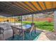 Covered back patio area with dining set and outdoor grill at 6726 S Franklin St, Centennial, CO 80122