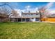 Backyard featuring a large, manicured lawn and covered patio at 6726 S Franklin St, Centennial, CO 80122