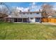 Backyard featuring a large, manicured lawn and covered patio at 6726 S Franklin St, Centennial, CO 80122