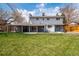 Backyard featuring a large, manicured lawn and covered patio at 6726 S Franklin St, Centennial, CO 80122