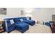Finished basement with a plush blue sectional, offering a cozy and inviting space for relaxation and entertainment at 6726 S Franklin St, Centennial, CO 80122