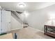 Partially finished basement with white staircase, neutral carpet, and ample space for customization at 6726 S Franklin St, Centennial, CO 80122