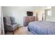 Spacious bedroom with a television, large dresser, chair and neutral tones, perfect for relaxation at 6726 S Franklin St, Centennial, CO 80122