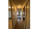 Hallway view showcasing tile flooring and access to multiple rooms; neutral color palette, simple design at 8826 E Florida Ave # 102, Denver, CO 80247