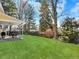 Expansive backyard features a well-maintained lawn and a covered patio, perfect for outdoor entertaining and relaxation at 7631 Oak St, Arvada, CO 80005
