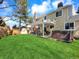 Spacious backyard featuring a well-kept lawn, covered patio, and hot tub, perfect for outdoor enjoyment and entertaining at 7631 Oak St, Arvada, CO 80005