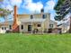 Lovely backyard showcasing a lush lawn, covered patio with seating, and a relaxing hot tub for outdoor enjoyment at 7631 Oak St, Arvada, CO 80005