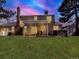 Dusk view of backyard featuring patio, hot tub, and lawn, offering a cozy and inviting outdoor ambiance at 7631 Oak St, Arvada, CO 80005