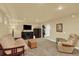 Finished basement with neutral walls and carpet, recessed lighting, and easy access to the basement kitchen at 7631 Oak St, Arvada, CO 80005
