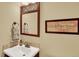 Cozy bathroom features decorative mirror and a warm color scheme with a cream-colored sink at 7631 Oak St, Arvada, CO 80005