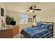 Cozy bedroom with blue bedding, ceiling fan, and dresser at 7631 Oak St, Arvada, CO 80005