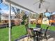 Inviting covered patio with outdoor seating and ceiling fans, ideal for enjoying meals and gatherings in the backyard at 7631 Oak St, Arvada, CO 80005