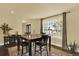 A dining room with natural light and a decorative rug underneath a wood table with seating for four at 7631 Oak St, Arvada, CO 80005