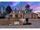 Charming two-story home with a well-manicured lawn, inviting front porch and attached two car garage at 7631 Oak St, Arvada, CO 80005