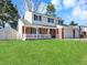 Charming two-story home with well-manicured lawn, shed, and a basketball hoop at 7631 Oak St, Arvada, CO 80005