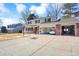 Charming home with a spacious driveway, basketball hoop, well-maintained yard, three car garage, and mature trees at 7631 Oak St, Arvada, CO 80005