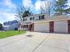Spacious house featuring well-maintained lawn, large driveway, and two-car garage at 7631 Oak St, Arvada, CO 80005