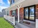 Charming covered front porch with brick accents and double door entrance adds curb appeal to this welcoming home at 7631 Oak St, Arvada, CO 80005