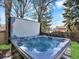 Relaxing backyard hot tub surrounded by trees under a bright blue sky at 7631 Oak St, Arvada, CO 80005