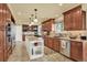 Spacious kitchen with stainless steel appliances, custom cabinets and a marble island counter top at 7631 Oak St, Arvada, CO 80005