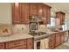 Gourmet kitchen featuring a gas range with stainless steel hood and granite counter tops at 7631 Oak St, Arvada, CO 80005
