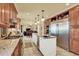 Large open kitchen featuring stainless appliances, a gas range and white center island with sink at 7631 Oak St, Arvada, CO 80005