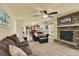 Inviting living room featuring a brick fireplace and seamless flow to the kitchen at 7631 Oak St, Arvada, CO 80005