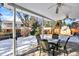Covered back patio with seating and backyard view at 7631 Oak St, Arvada, CO 80005