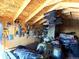 Interior view of a shed featuring four-wheelers, tools, equipment, ample storage, and wooden walls at 7631 Oak St, Arvada, CO 80005
