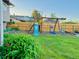 Backyard featuring a swing set, playset and a manicured lawn with a garden at 2118 S Mobile Way, Aurora, CO 80013