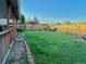 Spacious backyard featuring a large grassy area and playground set at 2118 S Mobile Way, Aurora, CO 80013