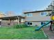 Backyard featuring a swing set, covered patio, and a lovely lawn at 2118 S Mobile Way, Aurora, CO 80013