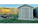 Backyard featuring a shed, a wooden fence, and a manicured lawn with a pond at 2118 S Mobile Way, Aurora, CO 80013