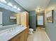 Bathroom features a sink, cabinet, and shower with neutral tile and modern fixtures at 2118 S Mobile Way, Aurora, CO 80013