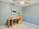 A bright bedroom offers soft neutral tones, a ceiling fan, and neutral carpeting at 2118 S Mobile Way, Aurora, CO 80013